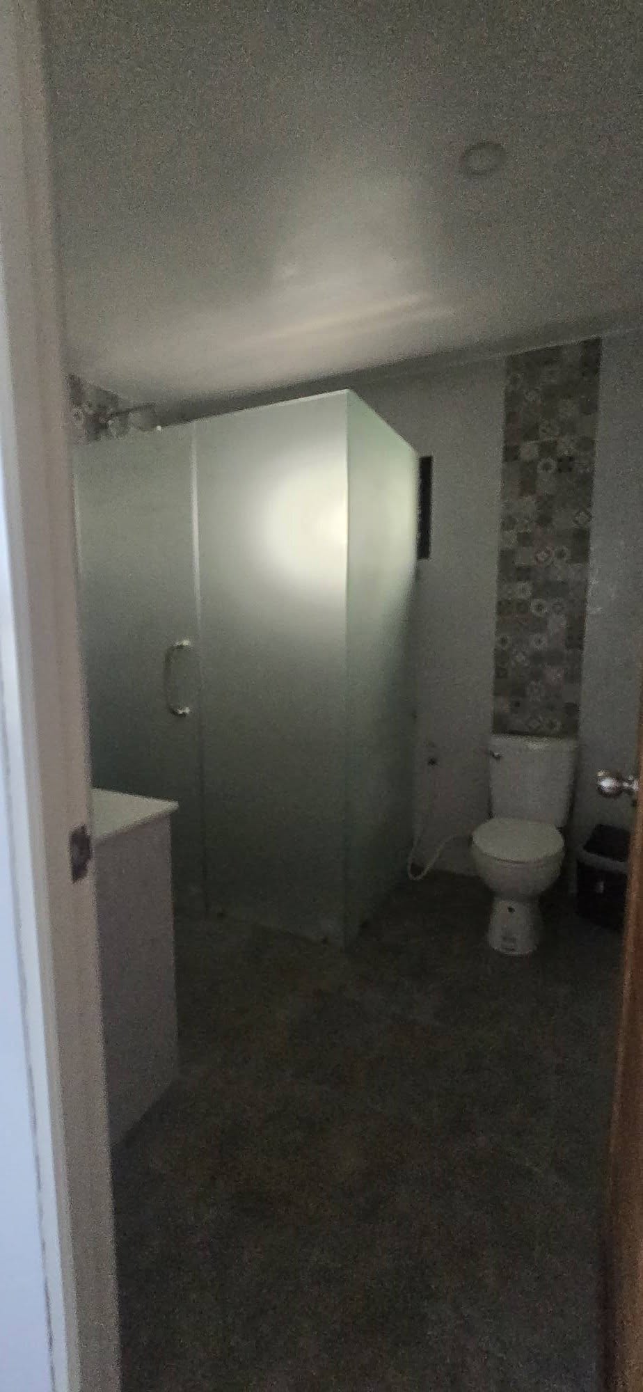 Clean modern bathroom shower enclosure with frosted glass panels