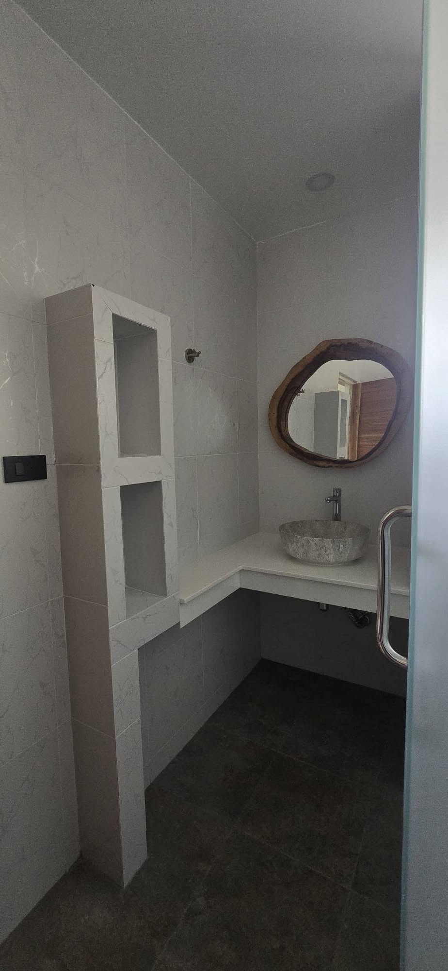 Bathroom with white vessel sink and live-edge wood framed mirror