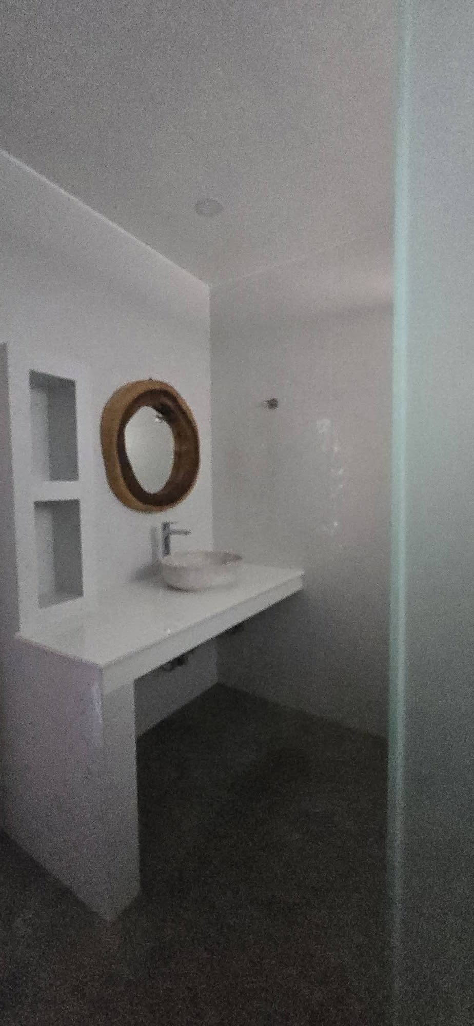 Second bathroom vanity with round vessel sink and organic wood mirror