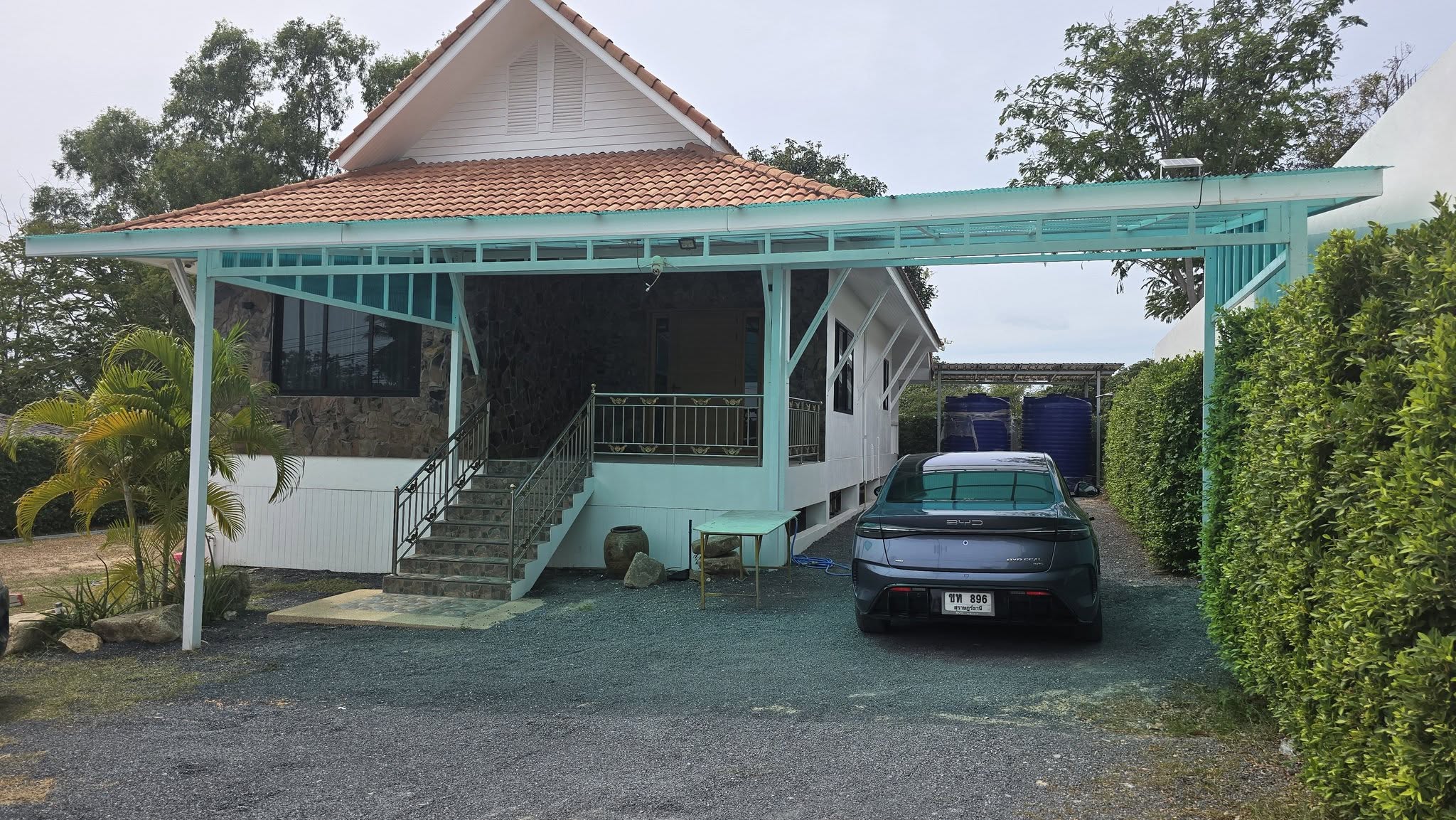 Exterior of the furnished villa with teal carport and terracotta roof on Bonkai Road, Koh Samui
