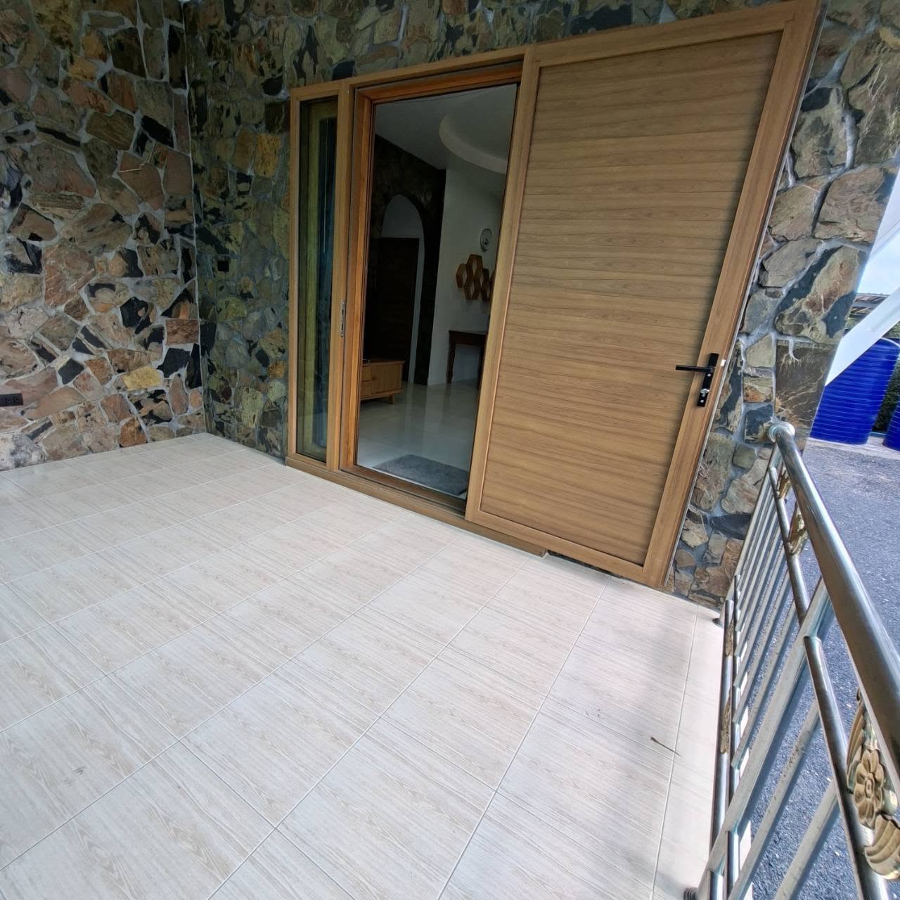 Covered patio and stone entrance of the Yui Villas Samui rental on Koh Samui
